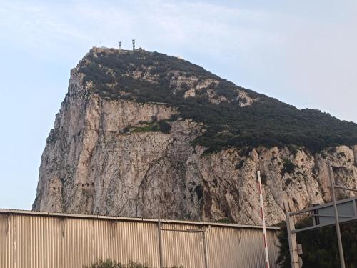 a mountain with a cross on top of it at E1 Studios, Sea & Beach Views, High Floor in Gibraltar