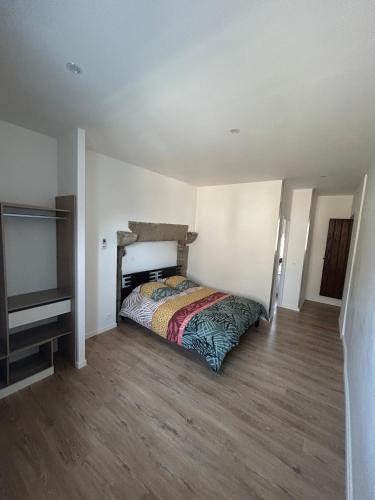a bedroom with a bed and a flat screen tv at Appartement entier proche château de Miniac-Morvan in Miniac-Morvan