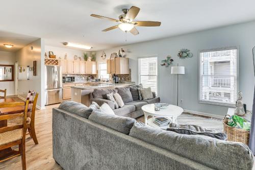 a living room with a couch and a table at Carolina Beach Condo with Deck Steps to Shore! in Carolina Beach