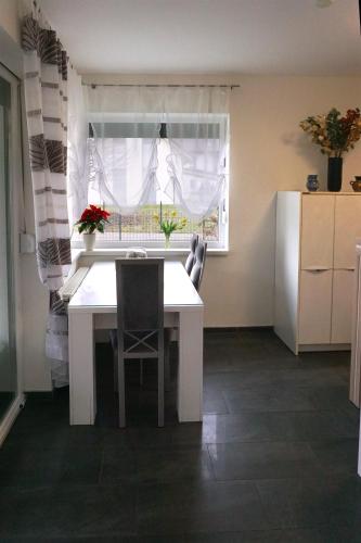 a kitchen with a white table and a window at Holiday home in a top location in Ferlach