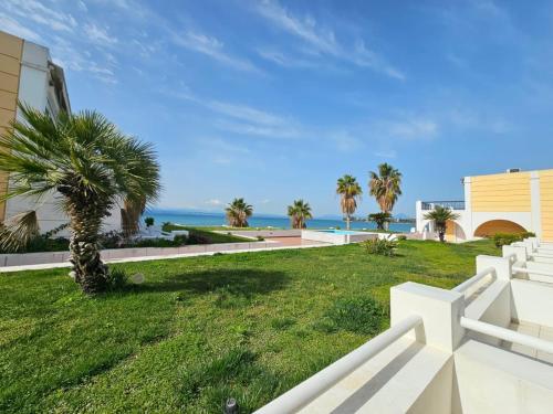 a view of the ocean from a house at Sunset on the Beach Apartment in Eretria