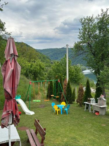 a backyard with a playground with a swing set at Weekend getaway house in Goražde