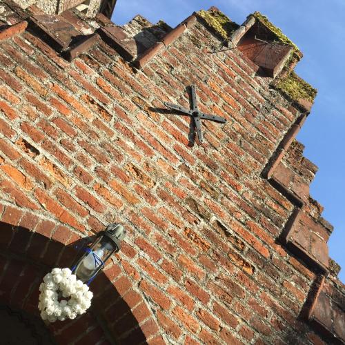 a brick tower with a clock on top of it at Sturmer Hall Hotel and Conference Centre in Haverhill
