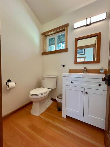a bathroom with a toilet and a sink at Jordan River Coastal Cottage in Shirley