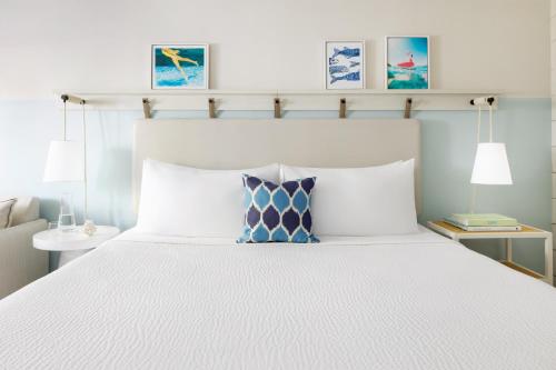 a bedroom with a large bed with a white bedspread at Blue Flamingo Resort Key West in Key West