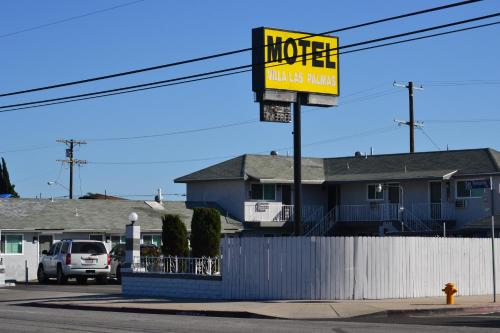 a sign in front of a house on a street at Villa Las Palmas Motel in Barton Heliport