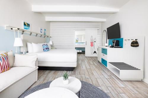 a living room with a bed and a couch at Blue Flamingo Resort Key West in Key West