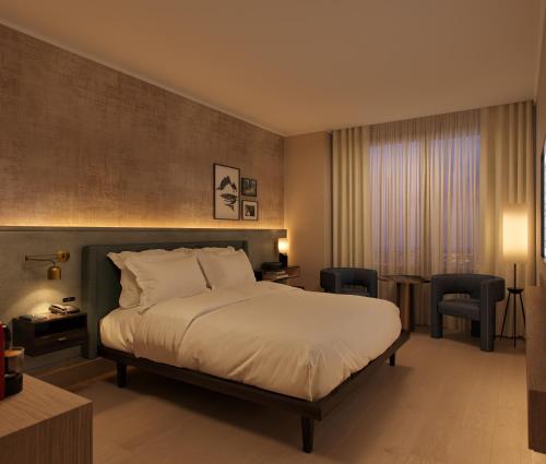 a bedroom with a bed and a table and chairs at The Rhyland in Flushing