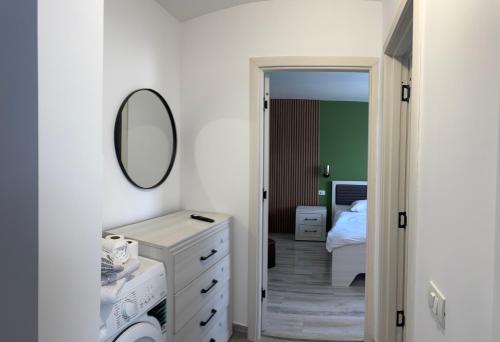 a bathroom with a white dresser and a mirror at LUXURY APAETAMENT CENTRAL Piatra Neamt in Piatra Neamţ