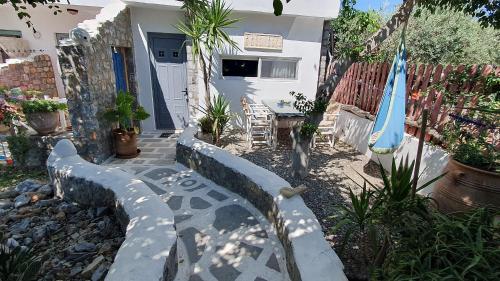 a house with a patio with a table and an umbrella at Pefkos Eye in Pefki Rhodes
