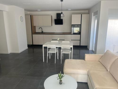a living room with a couch and a table with chairs at Inviting and bright 90 m2 residence with 4 balconies in Biograd na Moru