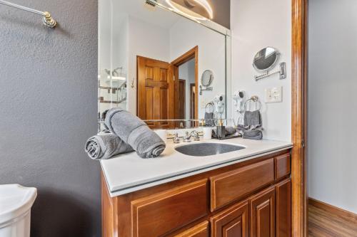 a bathroom with a sink and a mirror at Golf-Side Luxe Escape Sleeps 13 Hot Tub & Theater in Port Arthur