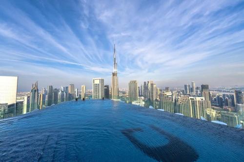 a infinity pool with a view of a city at Paramount - Luxury 2BR Apartments with Burj or Sea Views - Access to the Infinity Pool on 64th Floor in Dubai