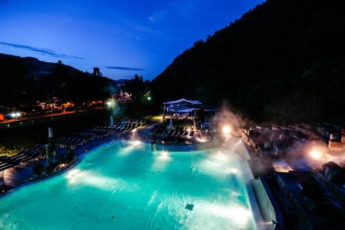 a large swimming pool at a resort at night at Euroterme in Bagno di Romagna