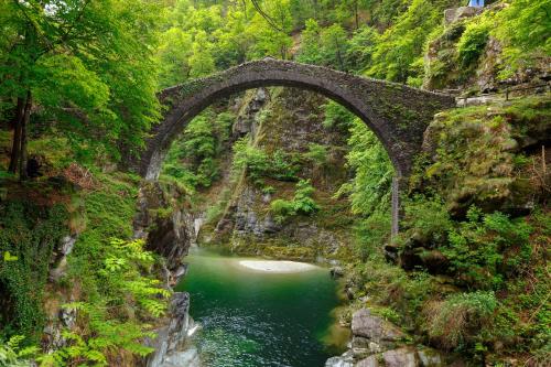 a stone bridge over a river in a canyon at Ca dal 1785 Centovalli - Happy Rentals in Intragna