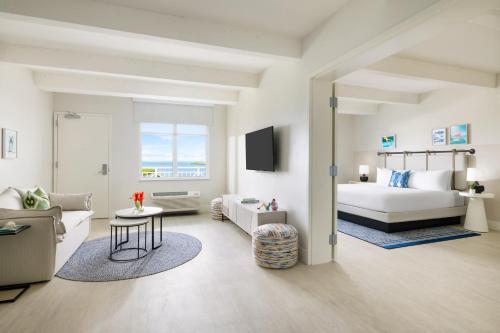 a bedroom with a bed and a living room at Blue Flamingo Resort Key West in Key West