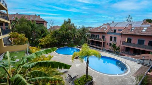 an overhead view of a courtyard with two swimming pools at Deluxe Living by LovelyStay in Funchal
