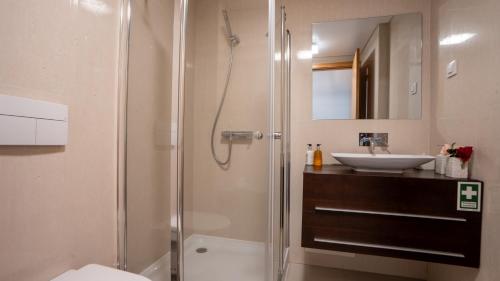 a bathroom with a shower and a sink at Deluxe Living by LovelyStay in Funchal