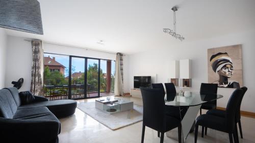 a living room with a table and chairs and a couch at Deluxe Living by LovelyStay in Funchal