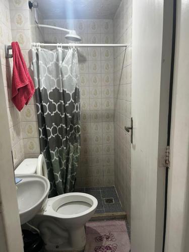 a small bathroom with a toilet and a sink at Hostel Farol da Barra in Salvador