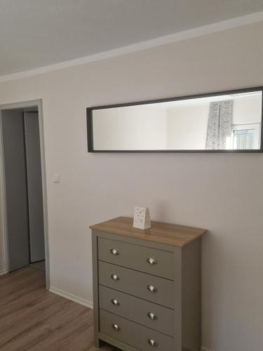 a bedroom with a dresser and a mirror on the wall at Gästehaus "Am weißen Stein" in Cochem