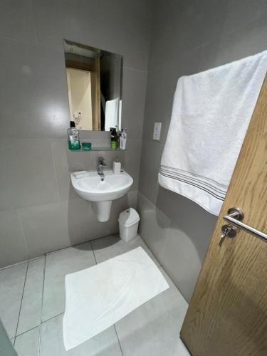 a bathroom with a sink and a toilet at Luxurious 2BHK apartment muscat bousher in Muscat