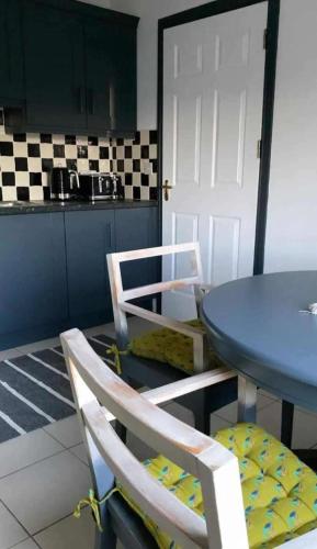 a kitchen with a blue table and two chairs at 3Br Apartment - Sleeps 7 - Free Parking - Athy in Athy