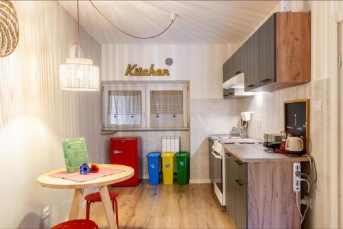 a small kitchen with a table and a counter at Casa Il sole, vicino Deruta Assisi Perugia Monte Falco in Deruta