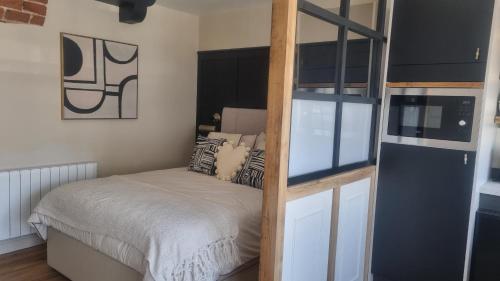 a small bedroom with a bed and a ladder at The Old Shop High Street in Llanidloes