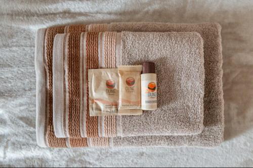 a towel with two bottles ofodorizers on a bed at Casa Il sole, vicino Deruta Assisi Perugia Monte Falco in Deruta
