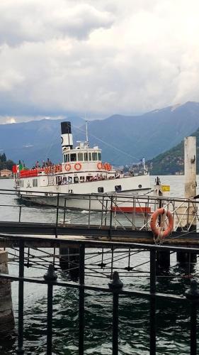 a boat is docked in the water near a dock at Casa vacanza PASsaggio in Como