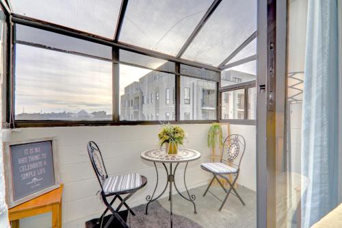a balcony with a table and two chairs at Spacious Top Floor at Stampede w Free Parking and AC in Calgary