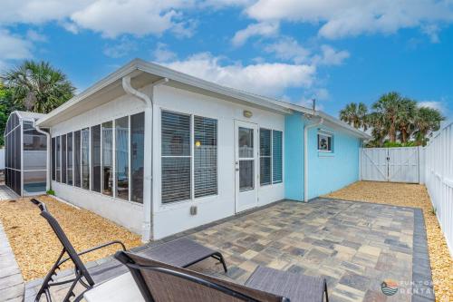 a blue and white house with a patio at Dog Friendly and STEPS from the Ocean! Big Beach House with Pool, BBQ & Garage in Chicken Island