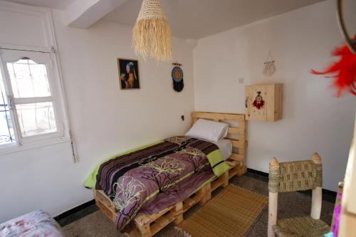 Postel nebo postele na pokoji v ubytování Jurassic Surf House Anza