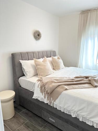 a bedroom with a large bed with white sheets and pillows at Romantic 3 Bedroom Apartment 3min from the beach in Kruševo