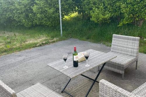 a table with a bottle of wine and two glasses at An Teach Beag - Dunmore East in Waterford