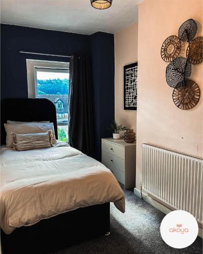 a bedroom with a bed and a window at Perfect Booking 3 Bed Home in Abertillery in Abertillery
