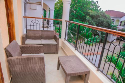 a balcony with two chairs and a table on a balcony at Hidden Jewel by the Creek in Kilifi
