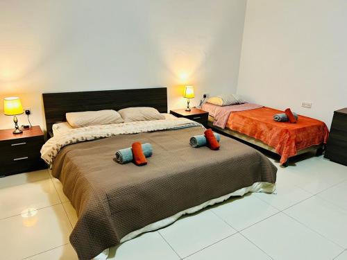 a bedroom with two beds with pillows on them at Huge and Stylish, St Julian's Central 2BR with 2 BATHS in St Julian's