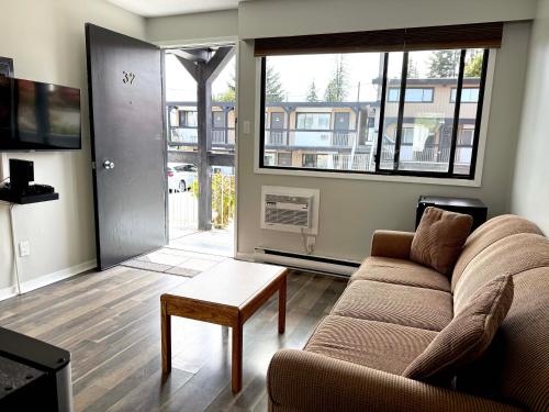a living room with a couch and a table at Departure Bay Motel in Nanaimo