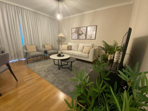a living room with a couch and a table at Modern Urban Apartment in Funchal