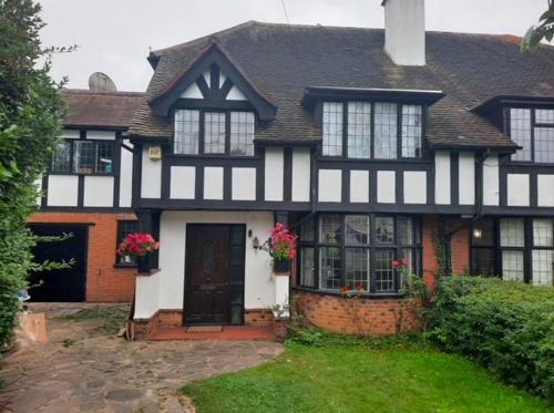 a black and white house with at Ibrahim's House in Chigwell