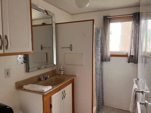 a bathroom with a sink and a shower at Camping Chalets Lac St-Augustin in Quebec City