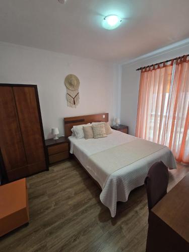 a bedroom with a large bed and a wooden floor at Verde Pinho in Geres