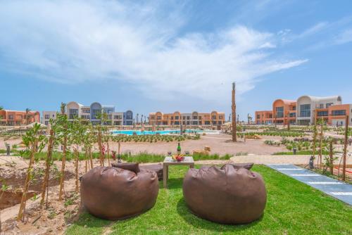 two large pots sitting on the grass in a park at Chic 1 BR with private jacuzzi in Banī Ghālib