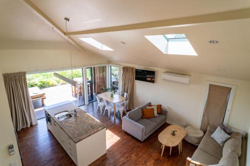 a living room with a couch and a table at Koru Lodge in Raglan