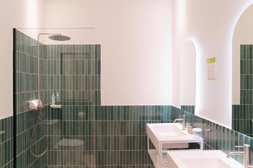a green tiled bathroom with two sinks and a shower at La Garoupe-Gardiole in Antibes
