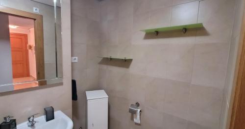 a bathroom with a sink and a toilet and a mirror at Ground floor family apartment, Close to Town and pool in Casas del Cura