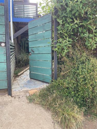 a blue fence in front of a house at Loft en Quintero in Quintero