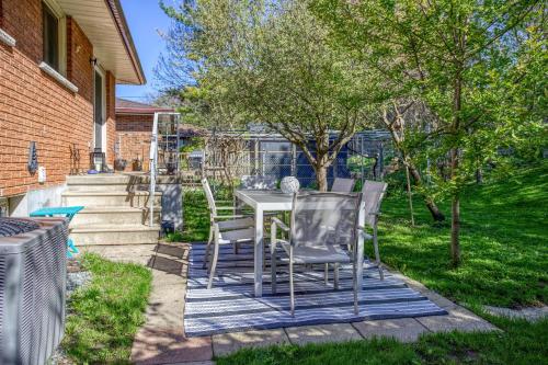 a patio with a table and chairs in a yard at Bright & Modern 1 bedroom unit! in Guelph